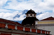 ber der Kuppel der Kirche blickt der Vulkan durch ein Wolkenfenster ...